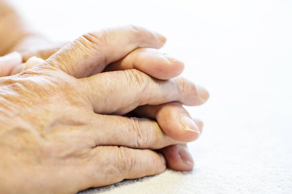 Photo of senior or elderly man wrinkled hands on white background.close up.