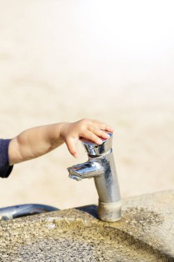 Genel Çeşme yaz şehir parkında çocuğun küçük el ile