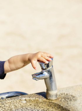 Genel Çeşme yaz şehir parkında çocuğun küçük el ile