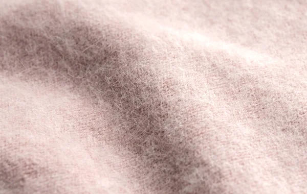 Rosa beige stickad ylle eller angora bakgrund. — Stockfoto