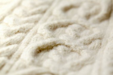 Pamuk veya yünden yapılmış beyaz desenli örme kumaşın arka plan dokusu.