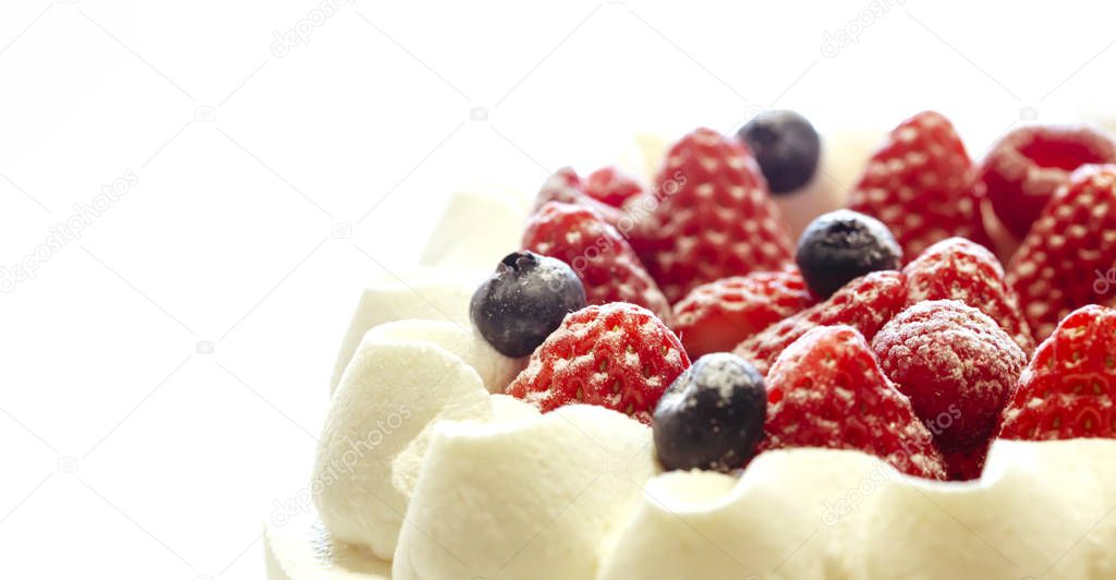 Strawberries and blueberries fresh cream cake isolated on white background.