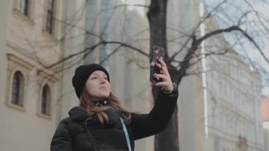 Avrupa şehirde kendi kendine portre çekici genç bir kadın. Beyaz turist Prag'da onu Avrupa bahar tatil keyfini
