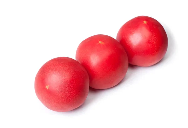 白い背景上に分離されていくつかの赤いトマト — ストック写真