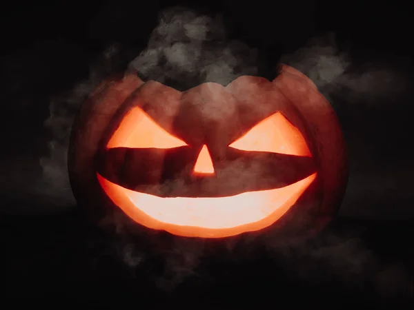Halloween pumpkin scary face Jack o Lanternon on dark background