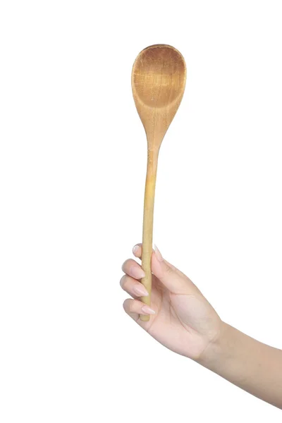 Wooden spoon in female hand — Zdjęcie stockowe