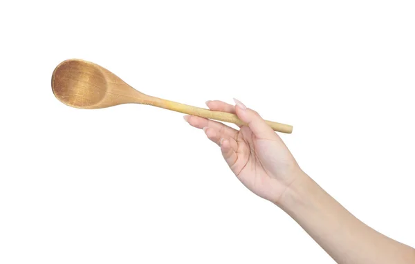 Wooden spoon in female hand — Stock Photo, Image