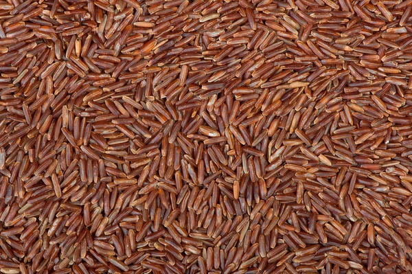 Superfície coberta com o arroz vermelho — Fotografia de Stock