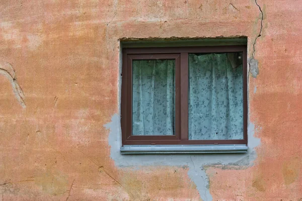 Old square window in a concrete wall