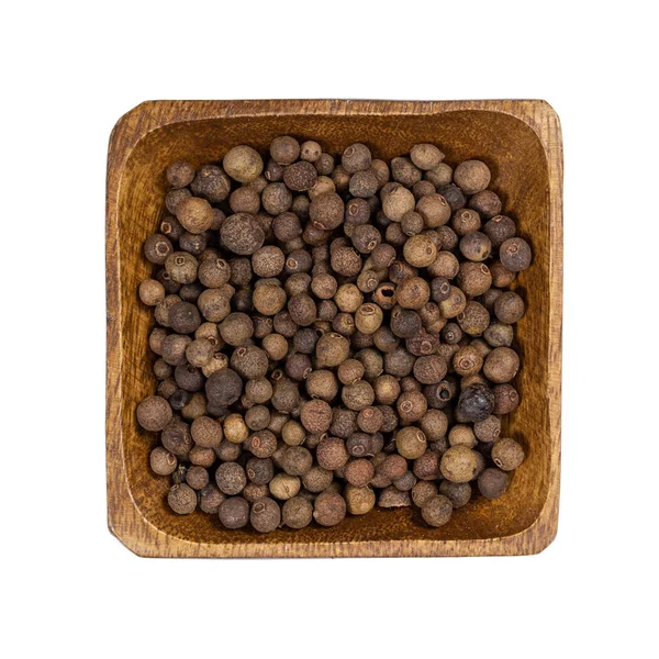 Allspice in wooden bowl isolated on white — Stock Photo, Image