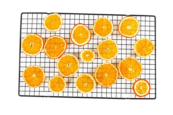 Dried orange slices on rack isolated on white background. — Stock Photo, Image