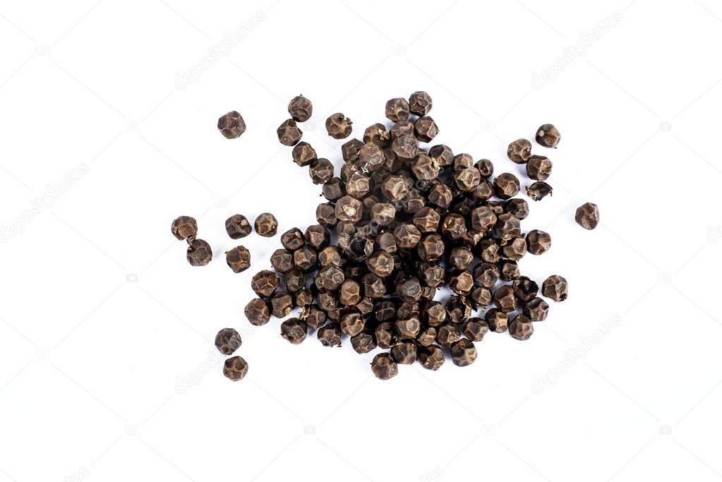 Black pepper corns on white background