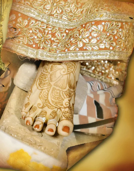 Indian bride touches her toe to the stone rituals ceremony