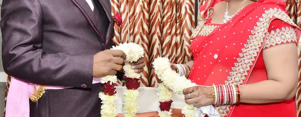 The bride and groom at the Indian wedding garlands or Jaimala ceremony