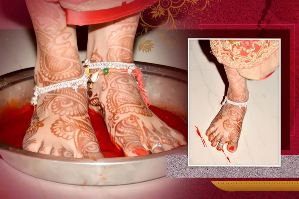 Griha Pravesh Ritual - Right feet of a Newly married Indian Hindu bride in Saree stepping in a plate filled with liquid kumkum before entering house for the first time