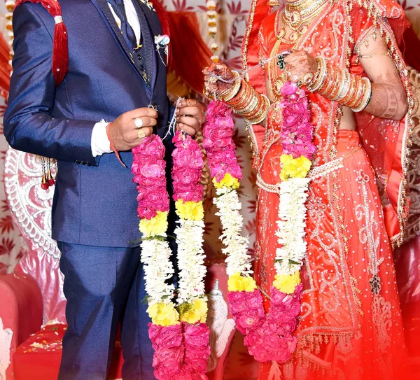 The bride and groom at the Indian wedding garlands or Jaimala ceremony