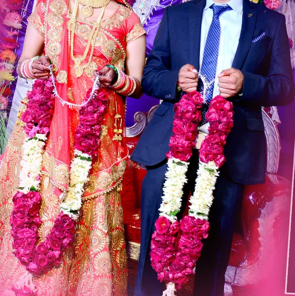 The bride and groom at the Indian wedding garlands or Jaimala ceremony