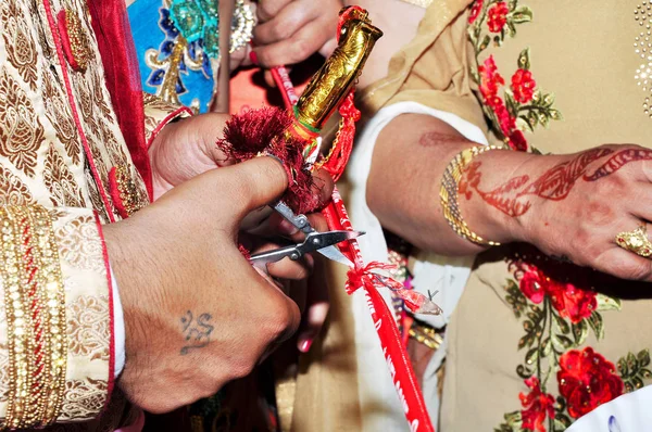 Cutting Ribbon in Indian Wedding Ritual Welcome Ceremony