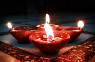 Hindistan 'daki Diwali Festivali' nde dua etmek için bir grup diya tapınakta.