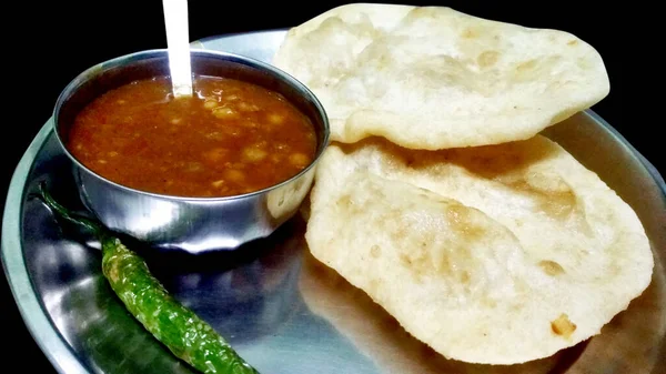 Chole Bhature: Indian dish spicy Chick Peas curry also known as Chole or Chana Masala is traditional North Indian main course recipe and usually served with fried puri / Bhature — Stock Photo, Image