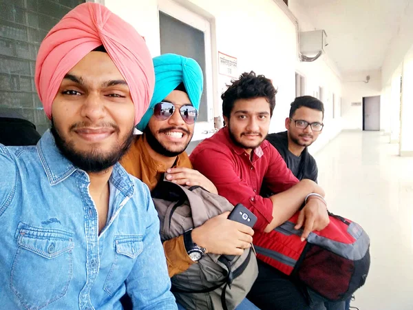 Rohtak, Haryana, India - 18 November, 2018: Close up of four cheerful friends in the spring, posing for a selfie shot, that handsome brunet is taking