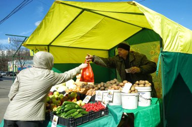 MOSCOW, RUSSIA - April 10, 2018: Street vending vegetables. Market weekend in Moscow. clipart