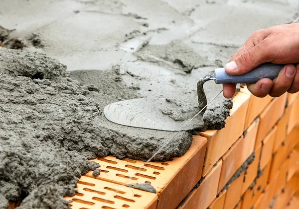 Brickwork hand with a trowel — Stock Photo, Image