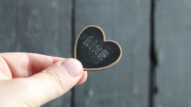 Like idea. Hand holds a heart shaped tablet — Stock Video
