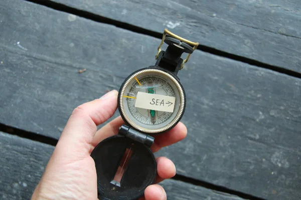 Pointer to the sea and an old compass. summer vacation concept. — Stock Photo, Image