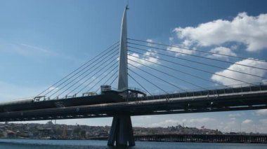 Golden Horn Metro Bridge spanning beautiful waterway in Istanbul Turkey with cable-stayed architecture and historic cityscape views showing modern transportation