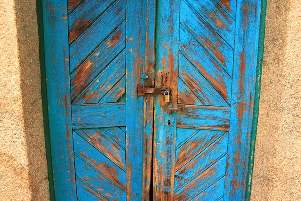 Old blue painted wooden door with lock