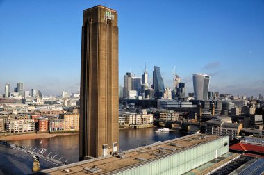 Tate modern famous chimney with the business district of London  clipart