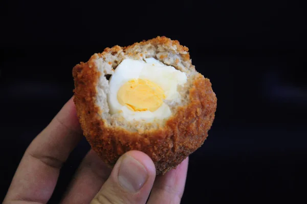 Traditional british food. Half eaten Scotch egg. Hard boiled-egg