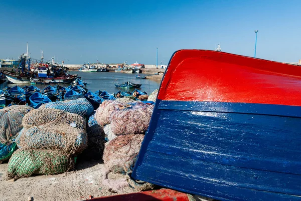 An overturned fishing boat on a dock at the port of Essaouira in Morocco