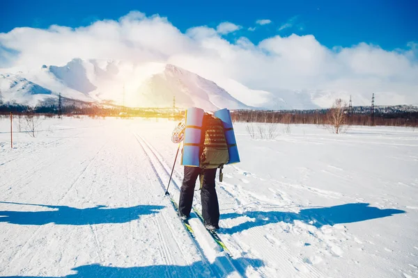 tourist on cross-country skiing goes hiking