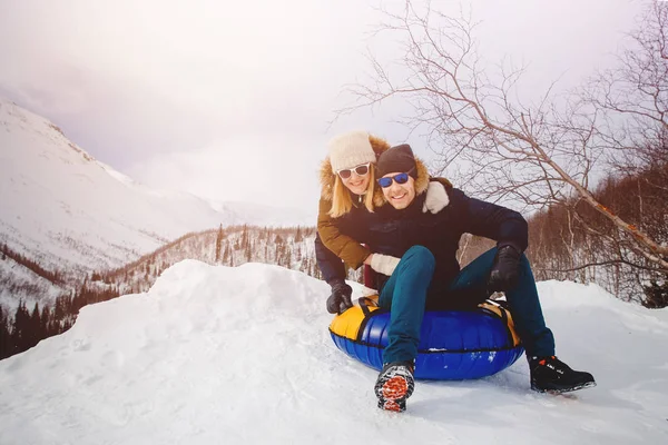 Onnellisia ihmisiä putkessa ulkona vuorilla talvella lunta — kuvapankkivalokuva