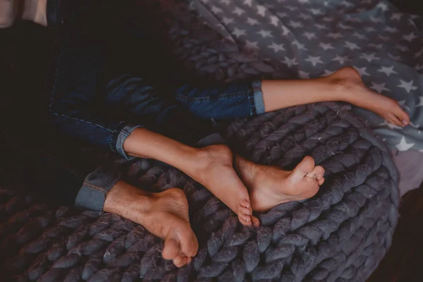 Couple man and girl lying in clothes pants blue on the bed