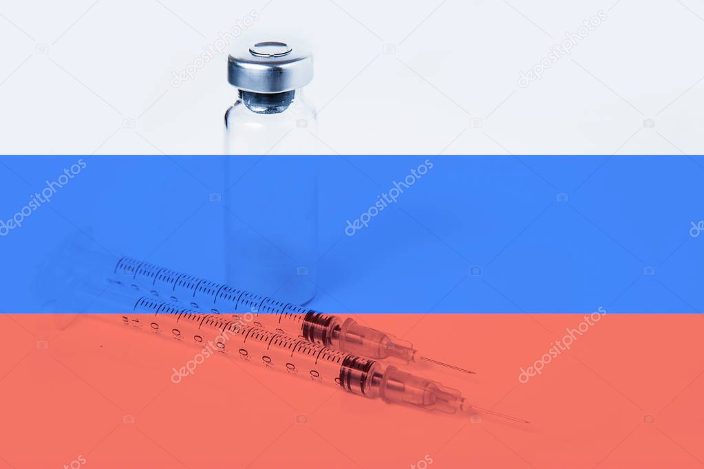 Medical syringe with doping against the background of the flag of Russia