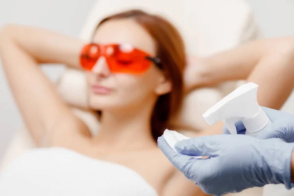 Underarm laser hair removal treatment woman. Process of preparing skin