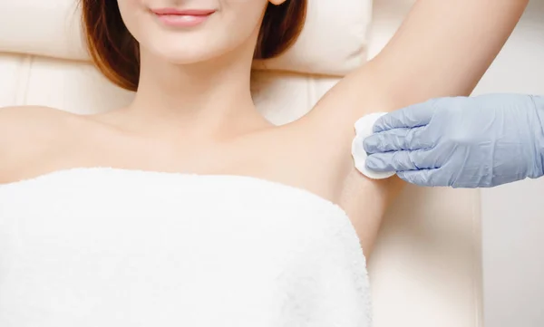 Underarm laser hair removal treatment woman. Process of preparing skin