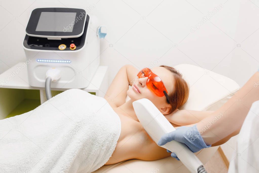 Process body care. Underarm laser hair removal treatment woman. Health and beauty