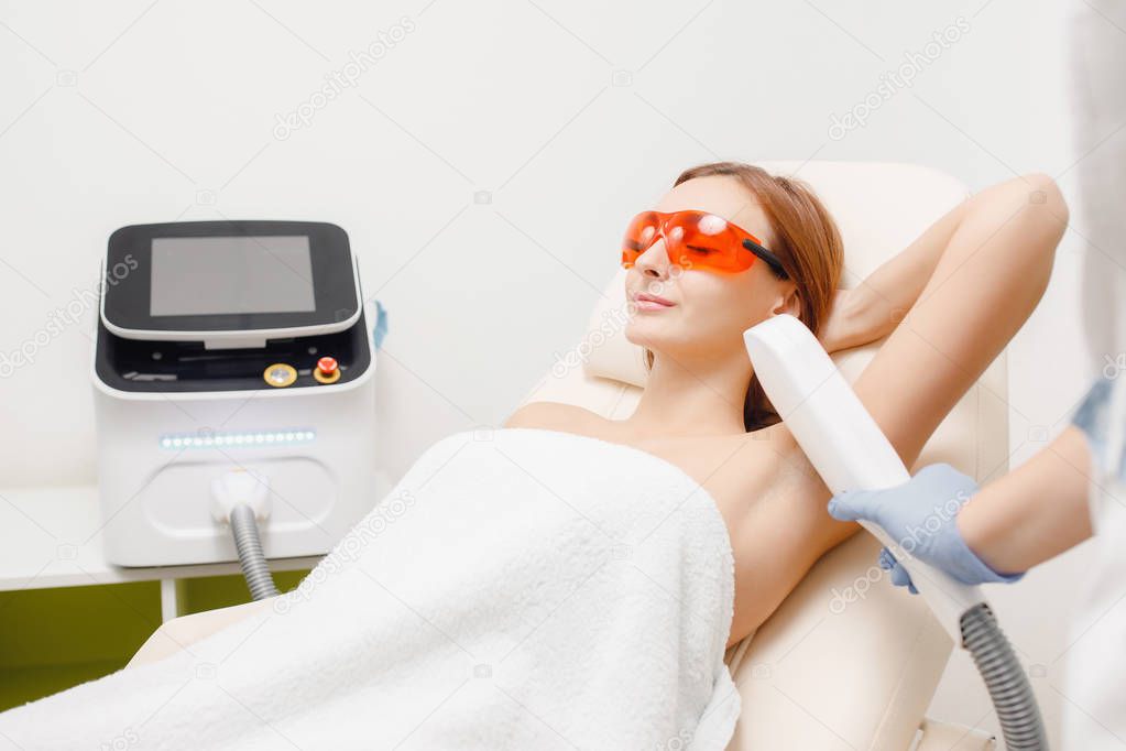 Smooth skin under arms. Young girl on laser hair removal
