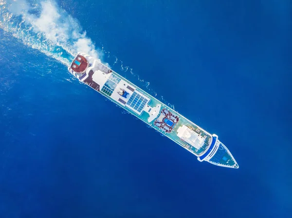 Cruise liner luxury ship in crystal blue Mediterranean sea water. Top aerial view