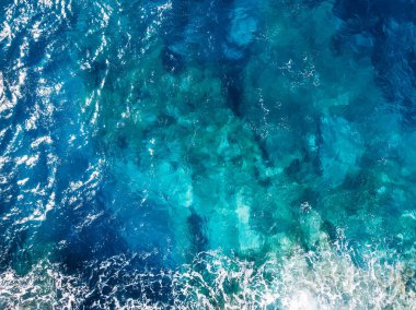 Raging blue water of open Mediterranean Sea with turquoise bottom. top view