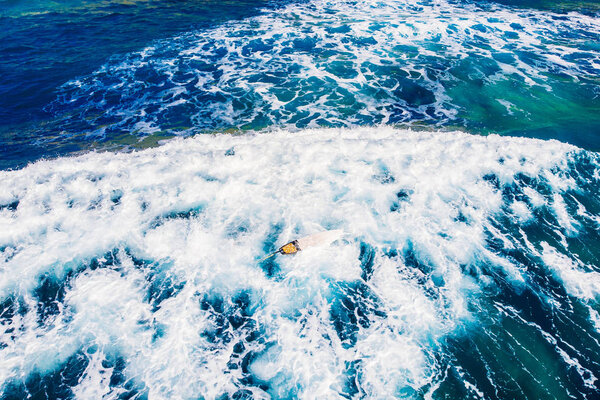 Group of novice surfers are learning to embark on wave. Aerial top view