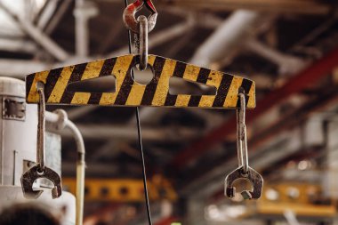 Bulanık depo arka planı ile vinç zinciri ve kanca. Konsept üretim çelik fabrikası