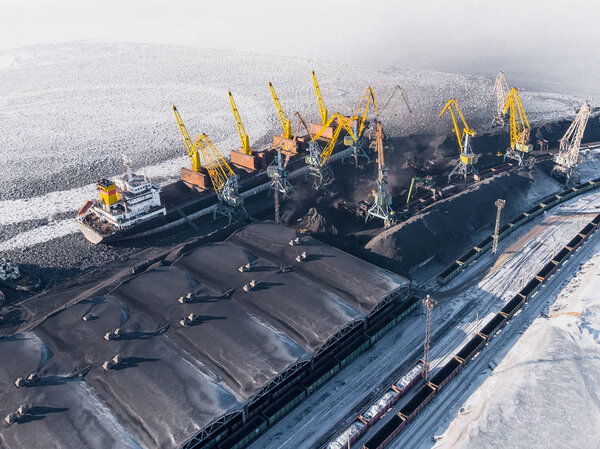 Industrial photo, Loading coal mining in port ship with crane. Aerial top view