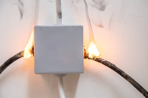 Electrical short circuit. Wiring cable on fire flame