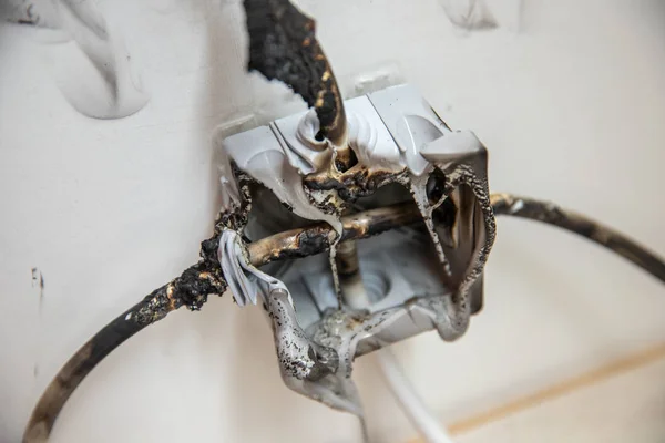 Electrical short circuit Effects. Failure caused by burning wire and rosettes socket plug in house