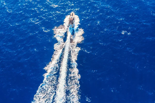 Luxe privé Speed motorboot verlaten blauwe zee. Bovenaanzicht van de luchtfoto — Stockfoto